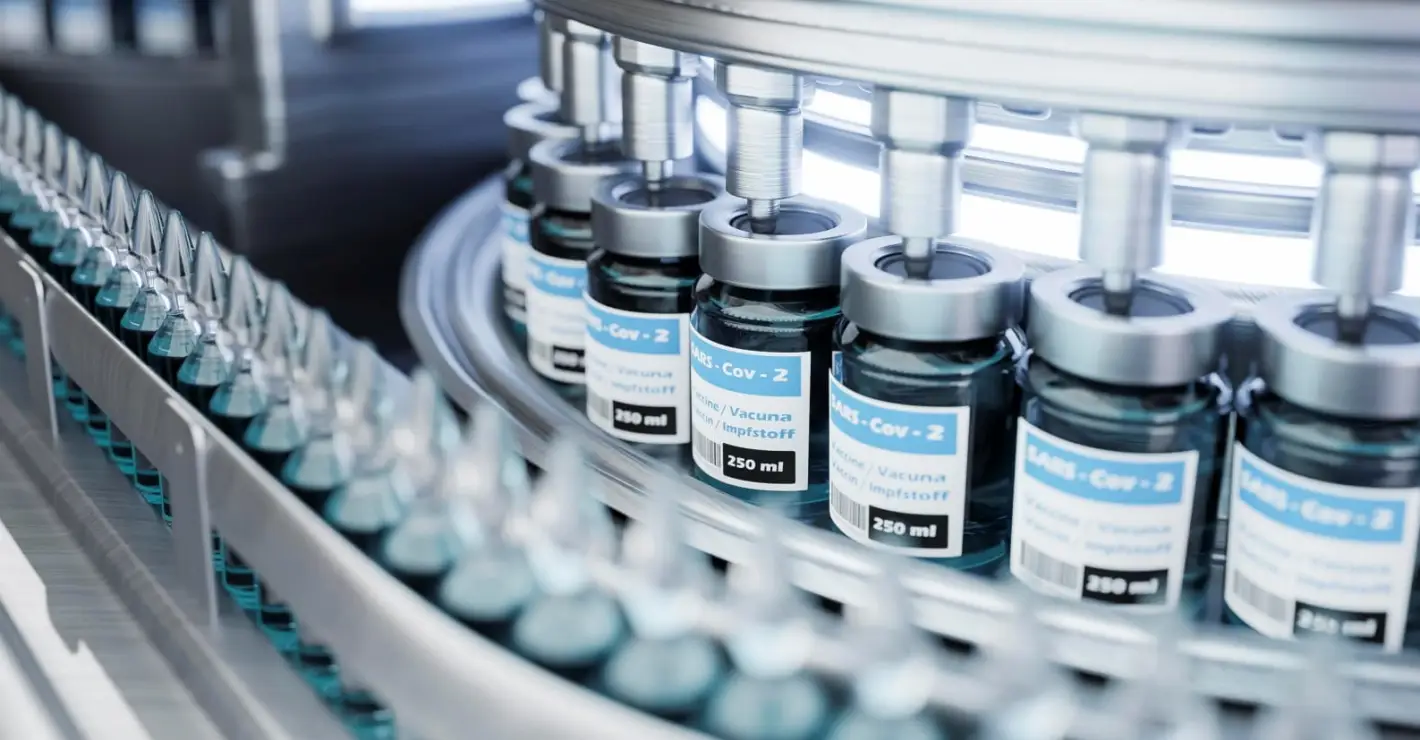 Automated pharmaceutical production line filling vaccine vials in sterile environment for cold chain storage and distribution